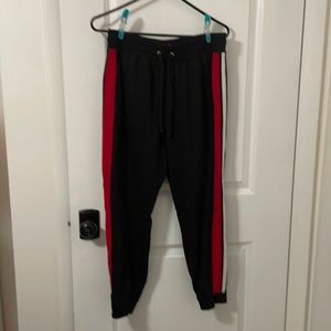 NY & Co black with red and white side stripes. Size: M
